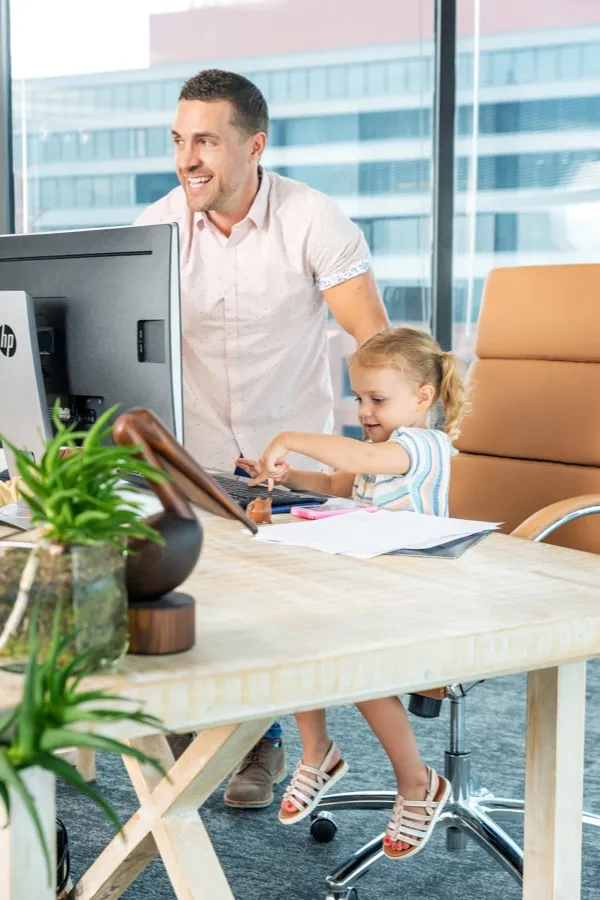 Alex with his daughter at his office