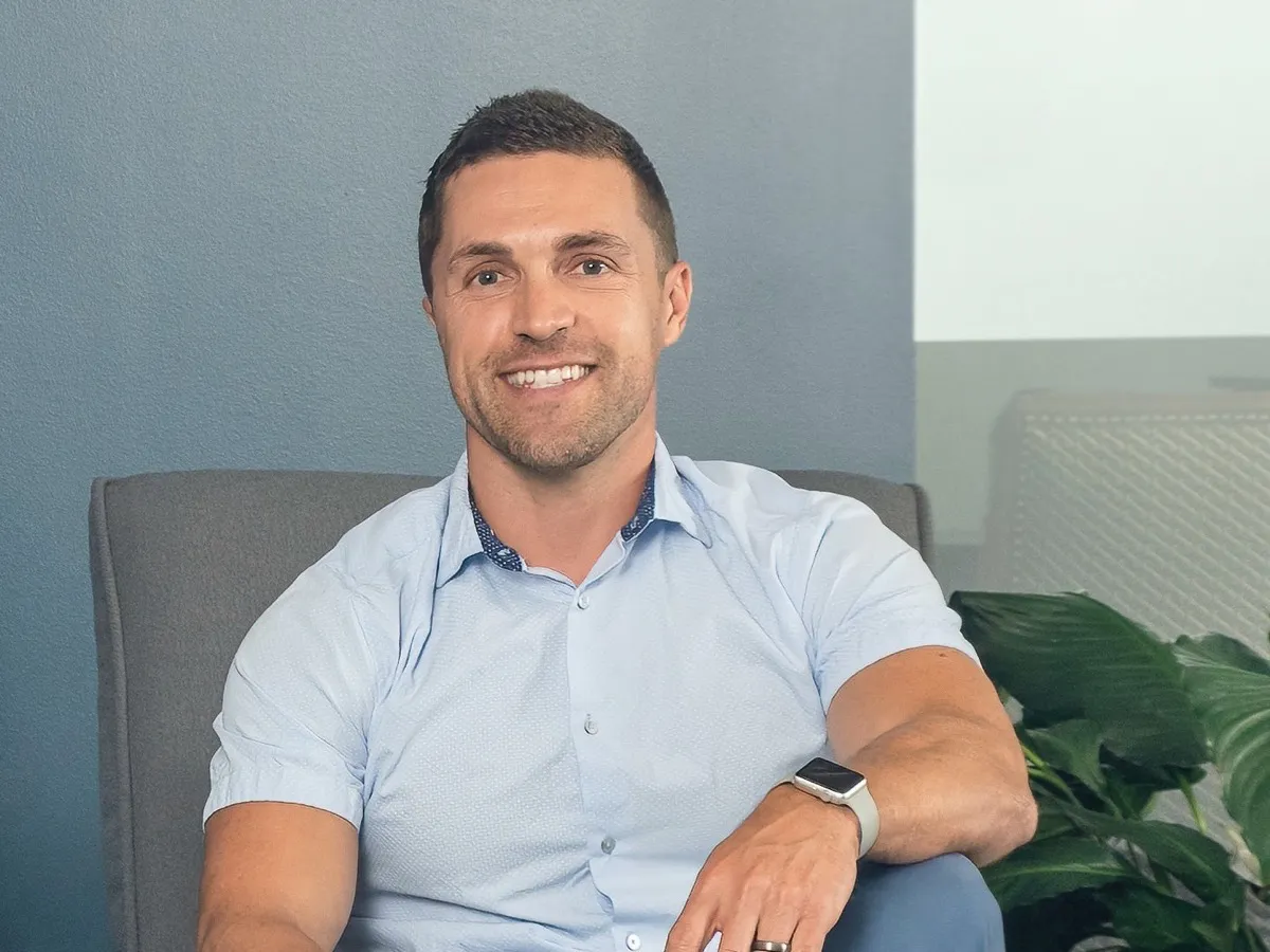 Alex Shafirovich, seated and smiling in a professional office setting